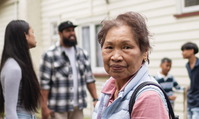 New Zealand lady outside with her family.